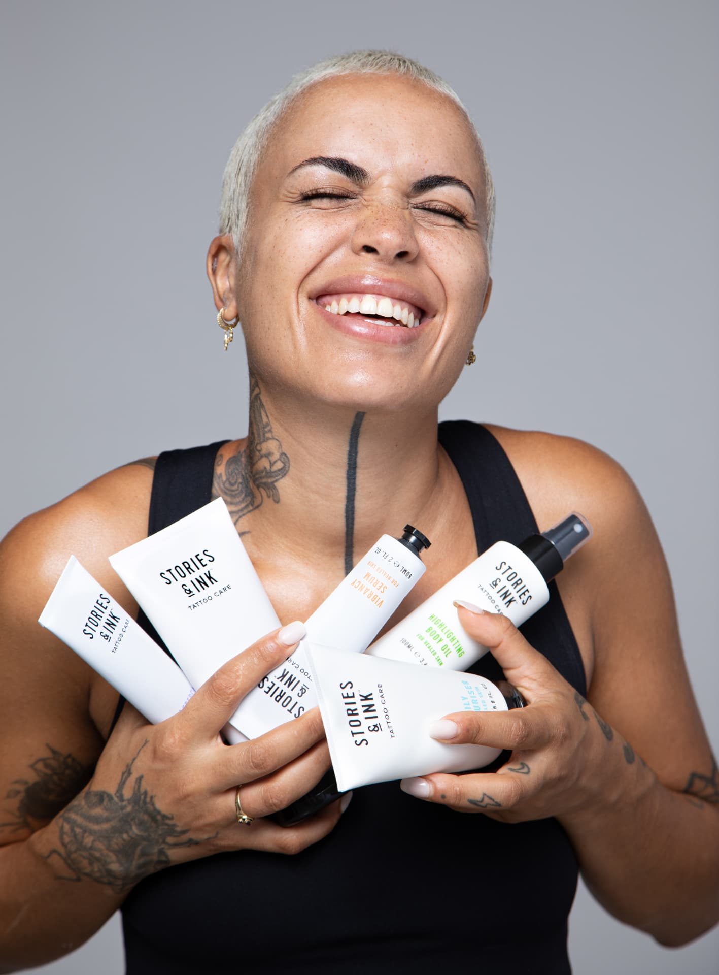 Person holding Stories & Ink tattoo care products